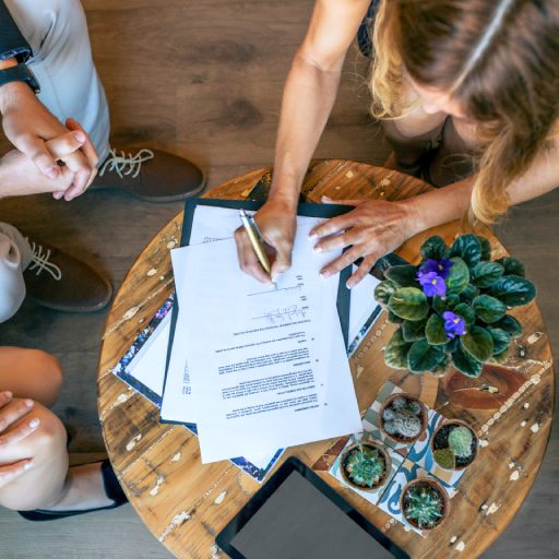 Top view of woman signing a document |  Will writing service Harrow