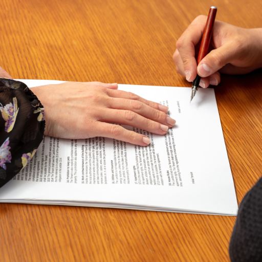 Agreement, business contract paper for signature. Woman and man hand on an office table, close up